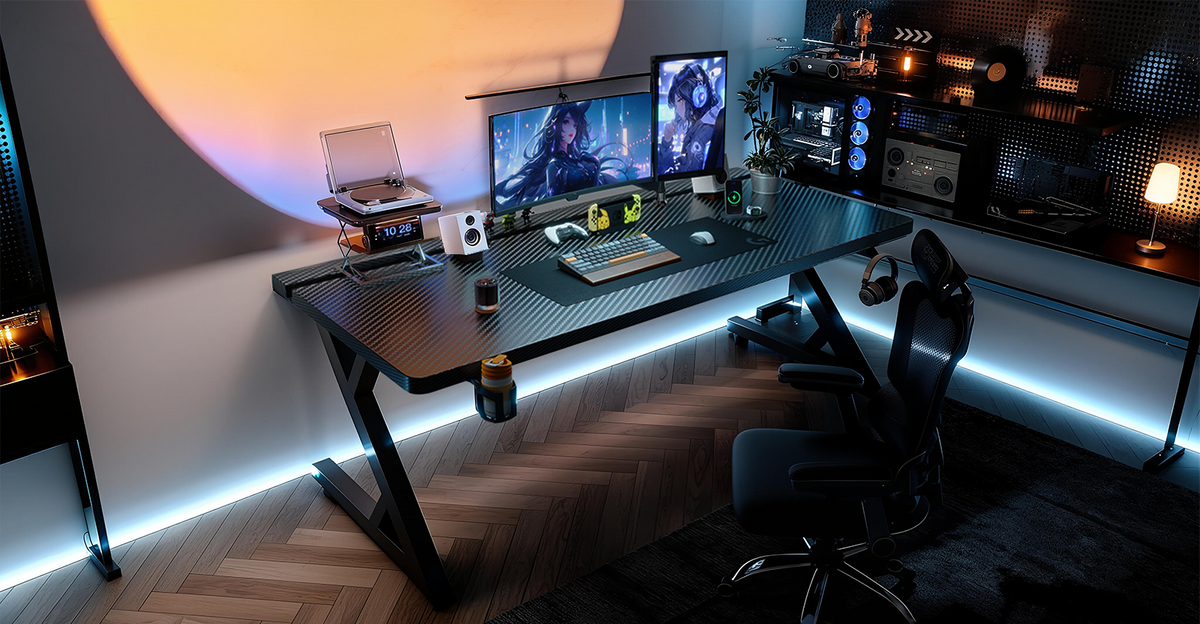 Black Z-frame desk with LED underglow, dual monitors and a sunset lamp glow on the wall