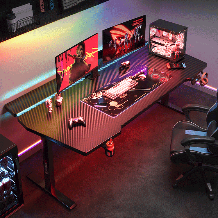 Black AGKey K2 gaming desk with RGB lighting, dual monitors and a PC tower in a dark gaming room