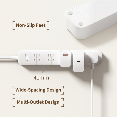 White Xiaomi power strip with wide-spacing multi-outlets, USB-A, USB-C adapters, power switch, and non-slip feet.