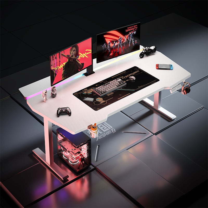 White K2 dual motor standing desk with carbon fiber texture, dual monitors, gaming accessories, and customizable LED lighting
