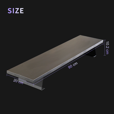 Black D1 Desk Monitor Riser with carbon fiber texture, measuring 90cm x 20cm x 10.2cm, angled side view on black background