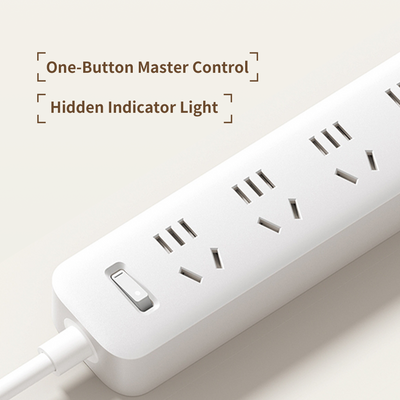 White Xiaomi power strip with multiple outlets, a master control switch, and a hidden indicator light.